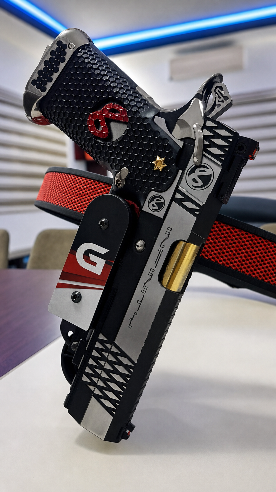 Enhanced close view of a black, silver and red custom competition pistol